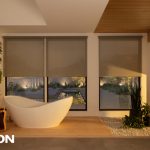 Modern luxury bathroom with a freestanding soaking tub, automated roller shades, floor-to-ceiling windows, warm wood ceiling accents, and soft ambient lighting overlooking a landscaped outdoor space.